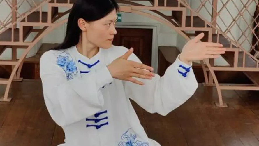 A women participating in Tai Chi in traditional attire
