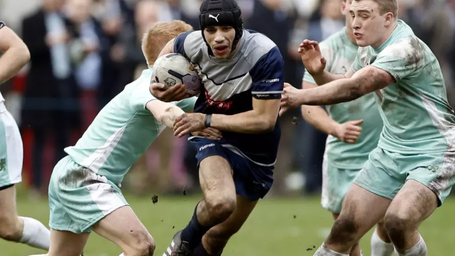 Several men playing rugby league in the Varsity match between Oxford and Cambridge