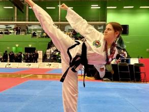 Eleanor Warrington doing a Taewondo kick