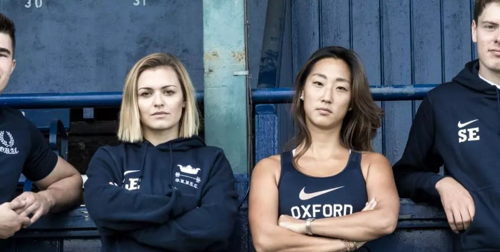 Four students posing in Nike branded leisure in Oxford Blue